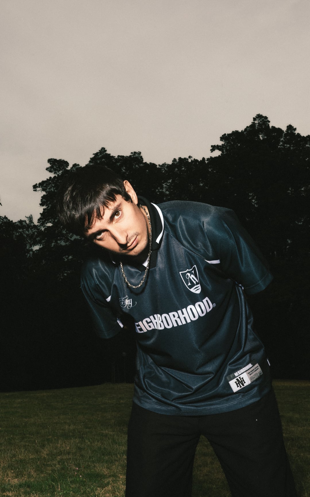 İlkan Ateş im dunkelblauen Fußballtrikot vor Bäumen